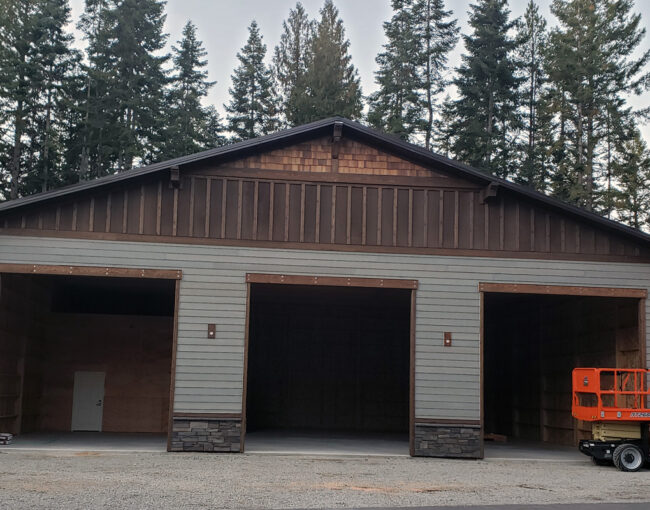 Custom 3-car garage build in Coeur d'Alene Idaho with durable exterior construction and a clean finished design