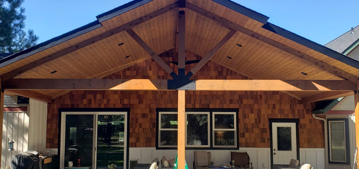 Custom covered patio project in Post Falls Idaho with timber roof framing and a finished outdoor living space