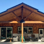Custom covered patio project in Post Falls Idaho with timber roof framing and a finished outdoor living space