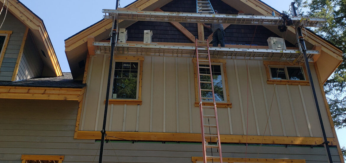 Exterior remodel project in Hayden Idaho with siding windows soffit and fascia improvements completed with scaffolding