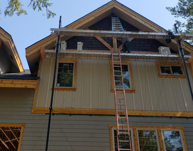 Exterior remodel project in Hayden Idaho with siding windows soffit and fascia improvements completed with scaffolding